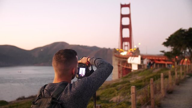 Man taking pictures of Golden Gate Bridge in San Francisco - Places to see for tourists - Professional camera DSLR - Sightseeing - 4k slow motion video