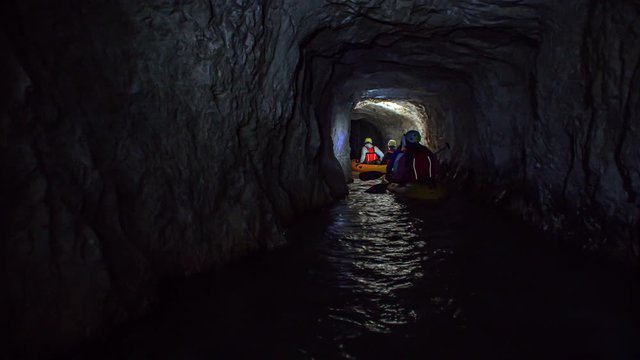 Friends in two kayaks explore the mysterious underground mine tunnels