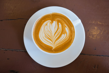 hot latte art coffee on wood table, relax time
