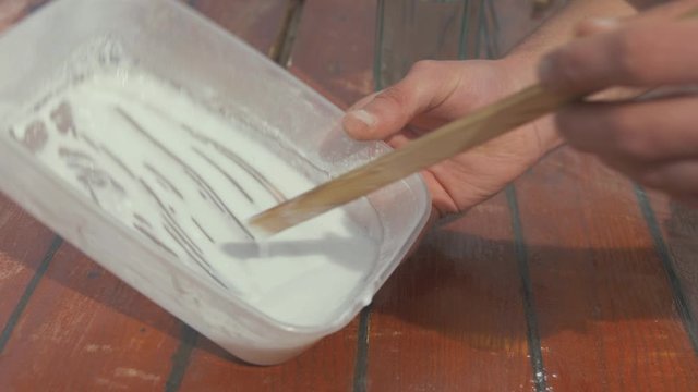 Mixing cascamite wood glue in tupperware container for wooden roof plank repair