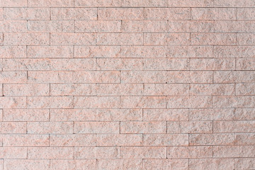 Cream colored bricks made of sandstone There is a small gravel mixed in the rock. The stone surface of the wall outside the house. Building strong walls using stones.