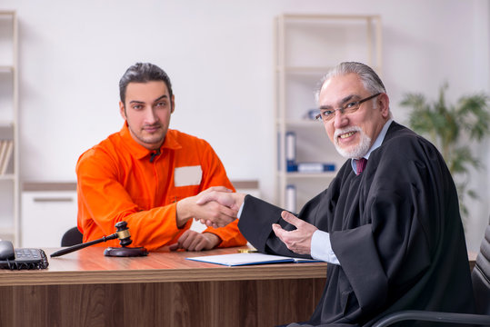 Old male judge meeting with young captive in courthouse