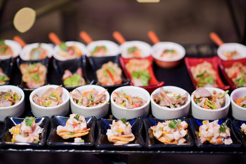 buffet food, catering food party at restaurant, mini canapes, snacks and appetizers
