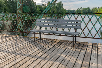 Bench on a rusty bridge walkway landscape