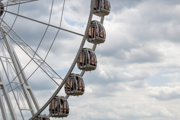 View of gondolas on a ferris wheel, fair background with copy space.