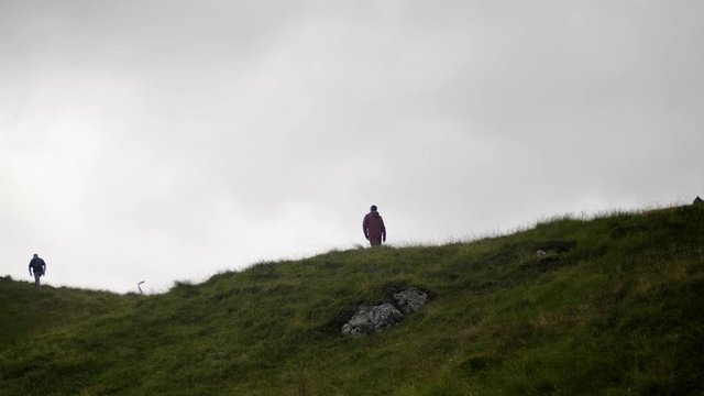 Show Motion Hikers Walking in the Top of Hill  with cloudy sky on Scotland