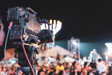 Professional digital video camera technician. Videographer with equipment at event.