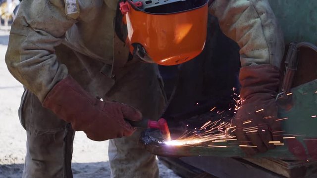 Blacksmith Worker Welding a Piece of Metal with Blow Torch - Medium Shot Slowmo