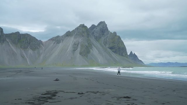 Young people exploring an iconic Icelandic westfjord beach