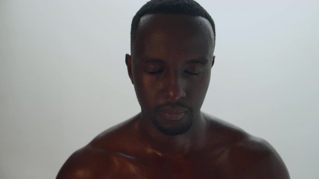 African American black male athlete takes a deep breath, close up frame. 4K.