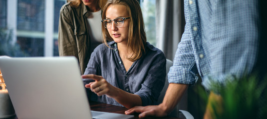 Young business people working together on new project. Colleagues at coworking. Startup concept.