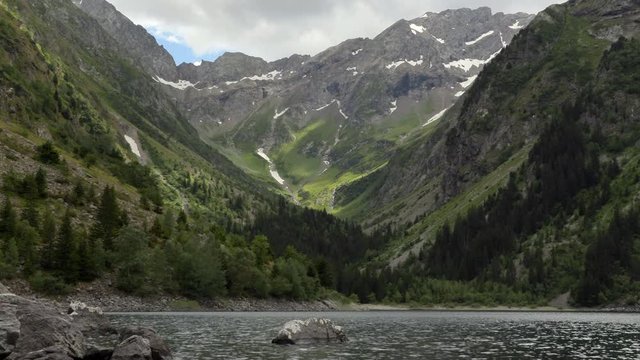 Smooth zoom in from a wide angle view of Lauvitel lake to the detail of the perma snow from the glacier. 4K ProRes