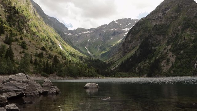 Gimbal dolly shot stepping into the beautiful Lauvitel lake in Venosc, Alps. 4K ProRes
