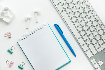 Stylish minimalistic workplace with keyboard, notebook, office plant, notebook in flat lay style. White background. copy space, flat lay, top view, mock up