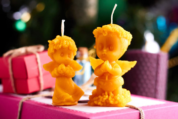 Two Christmas candles of little angels - boy and girl