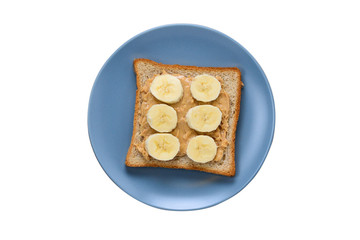 Peanut butter toast with banana slices isolated on white.