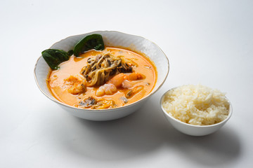 Traditional Asian soup with chicken or pig meat with udon noodles in a white bowl, isolate.