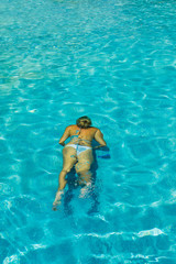 Woman in bikini at swimming pool