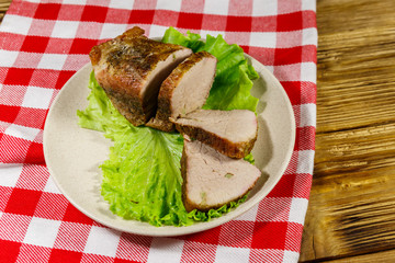 Tasty baked pork with spices on a wooden table