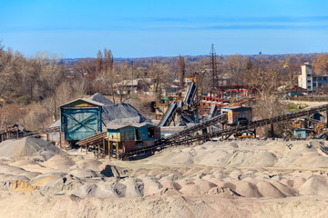 Rock crusher machine, crushing machinery, conveying crushed granite gravel stone in a granite quarry. Processing plant for crushed stone and gravel. Mining equipment