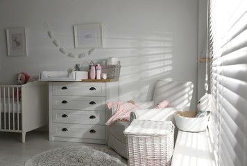Fototapeta na wymiar Chest of drawers with changing tray and pad in baby room. Interior design