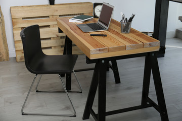 Comfortable workplace with office chair and wooden table