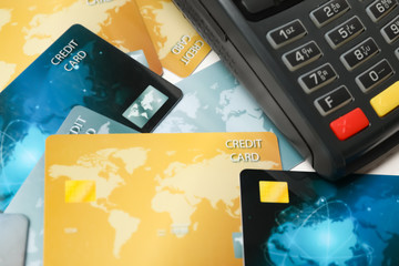 Many different credit cards and payment terminal, closeup