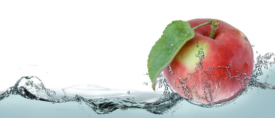 Fototapeta na wymiar Ripe apple in splashes of water