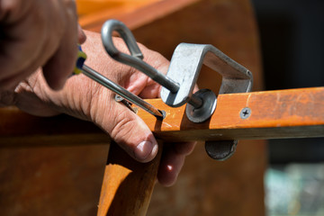 a self-isolation class is a chair repair. Grandfather repairs a chair on the street, using screws, glue, and a Vice.