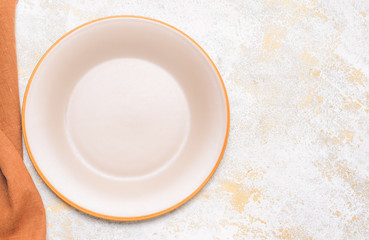 Clean plate with napkin on white background