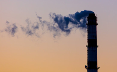 Smoke from the chimney at the factory against the backdrop