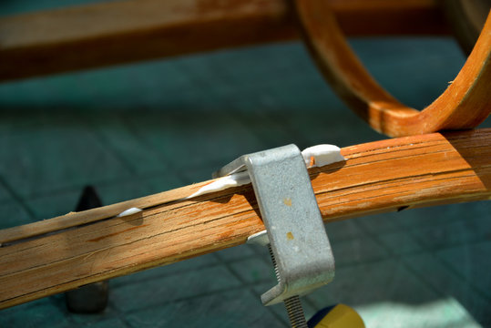 A Self-isolation Class Is A Chair Repair. Grandfather Repairs A Chair On The Street, Using Screws, Glue, And A Vice.