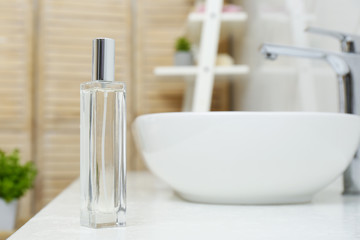 Fototapeta na wymiar Bottle of air freshener on counter in bathroom