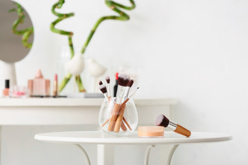Set of makeup brushes on table