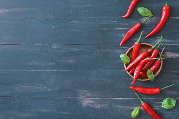 Hot chili pepper on dark wooden background