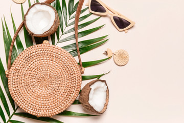 Wicker bag with female accessories on light background