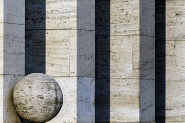 Stone ball in front of a row of columns