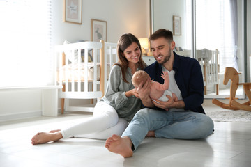 Happy couple with their newborn baby at home - Powered by Adobe