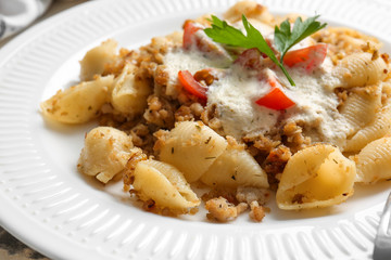 Plate with tasty conchiglie pasta, closeup