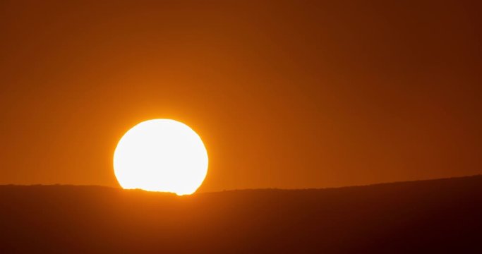 Big sun close-up rising at mountain.	 Beautiful nature video time lapse landscape.