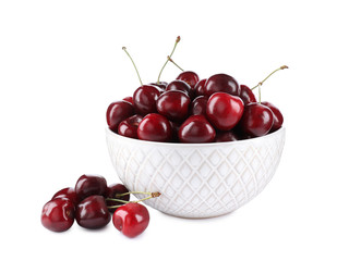 Tasty ripe red cherries and bowl isolated on white