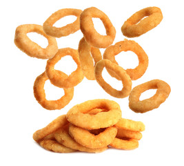 Fried onion rings falling on white background