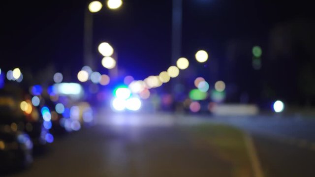 Blue police lights blinking on street, car accident, bokeh circles in background