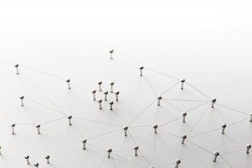 Linking entities. Network, networking, social media, connectivity, internet communication abstract. A small network connected to a larger network. Web of thin silver wires on white background.