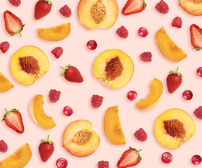 Layout with peaches, strawberries, cranberries and raspberries on pale pink background, top view
