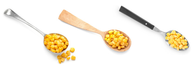 Set of spoons with delicious canned corn on white background, top view. Banner design