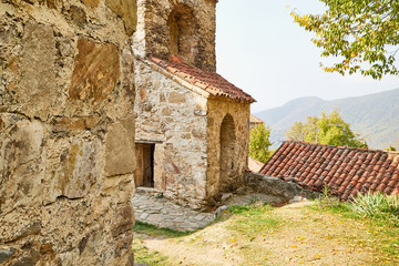 Fototapeta na wymiar Orthodox church in Jvari Monastery located near Mtskheta, Georgia. Old house built of yellow stones and bricks.
