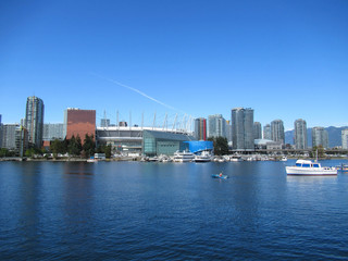 Fototapeta na wymiar BC Place stadium, sea bay, houses and boats in Vancouver at summer.