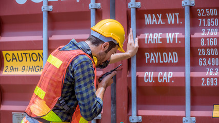 Dock worker under discussion about dock container shipping warehouse working, he wearing safety...
