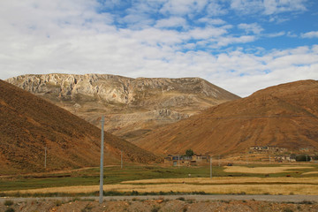 Tibetan Village and the highland barley field in cloudy day, Tibet, China 